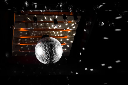 Shiny bright highlight, disco, silver white ball, on the ceiling of a nightclub, atmosphere,...