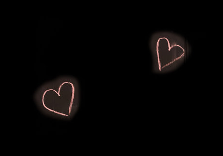 Sign and symbol of love, relationships, romance, hearts, object drawn colored crayon on a black background, close-up.の写真素材