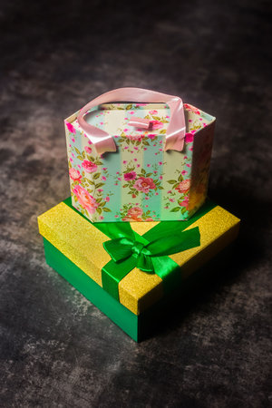 New Year's gifts, a beautiful gift box with a ribbon on a gray background.の写真素材