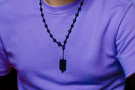 Men's style clothing fashionable lilac T-shirt with a decoration around the neck close-up.の写真素材