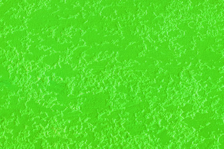 Bright green verdant rough texture plaster wall surface stucco background cement concrete.の写真素材