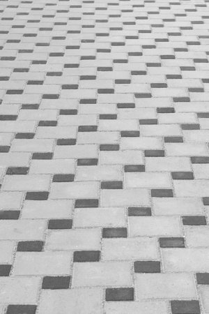 Dark and gray floor tile stone texture surface street city background paving abstract pattern structure.の写真素材