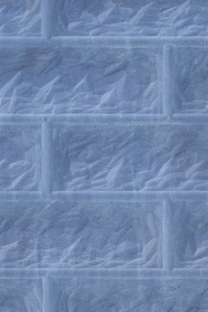 Close-up vertical texture blue brick wall blocks abstract pattern background structure.