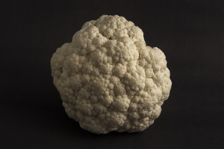 Couple of cauliflower and broccoli on a dark background, with theatrical lighting. Fresh vegetables. Dark cauliflower.の写真素材