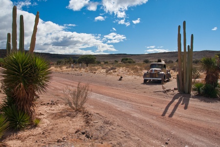 Rusty car in desertの写真素材