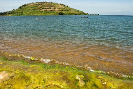 The view of rocks covered with moss on the side of the lake, Rwandaの写真素材