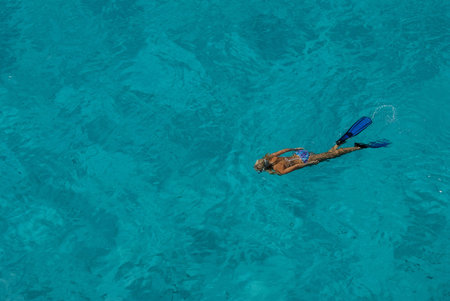 A female freediver in the clear blue water of the Mozambique Channel, Bassas Da india