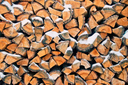 background image of snow covered pile of pine firewood の写真素材