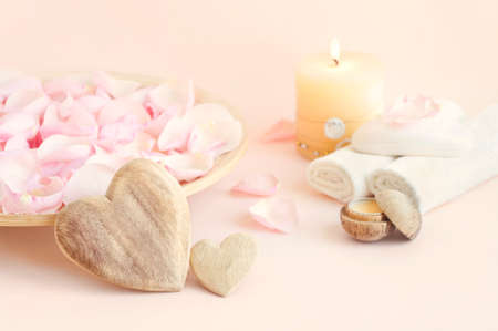 still life image of rose petals, towels, massage oil and candle for spa treatment for couple as valentines day giftの写真素材