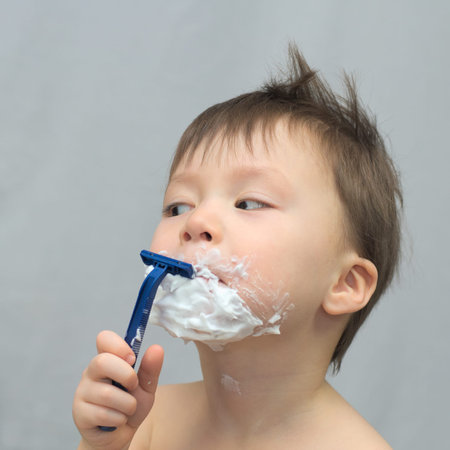 White caucasian young man shaving his beard