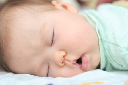 Newborn baby sleeps with his mouth open