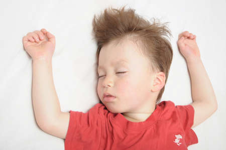 European caucasian Kid sleeping arms outstretched の写真素材