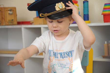White caucasian Boy in the cap playing in kindergartenのeditorial素材