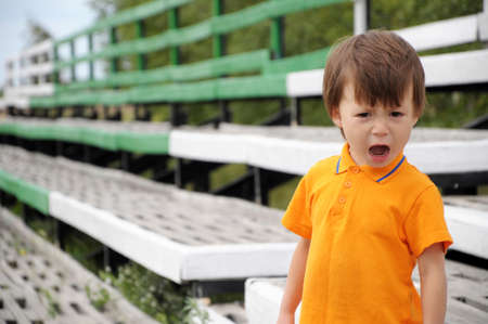 boy screaming in discontent, outdoor, summer timeの写真素材