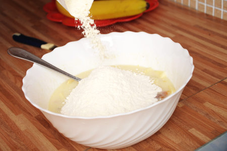 Adding flour in dough for cooking pieの写真素材