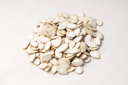 white Cucurbitaceae seeds on the gray background