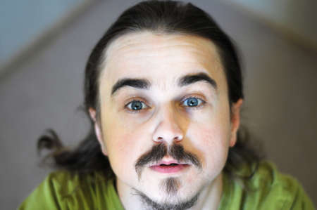 Looking up face portrait of young manの写真素材