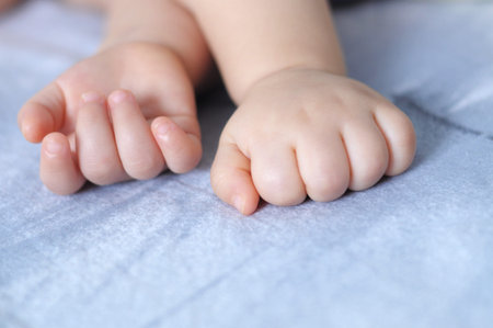 Sleeping caucasian quite baby finger close upの写真素材