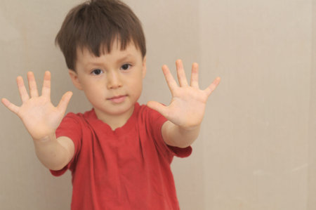 Boy with hands in front of himself like saying stop