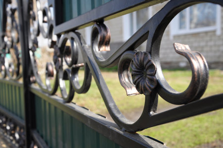 welded iron metallic fence flower detail closeup