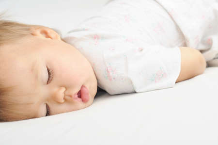 Baby cute sleeping portrait in loose jacketの写真素材