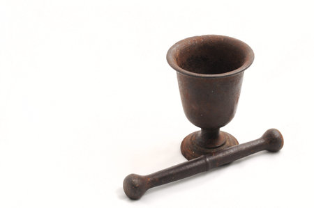 Vintage mortar with a pestle isolated on white