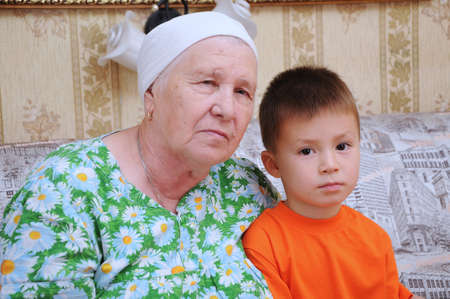 Grandmother and grandson portraits in a home environmentの写真素材