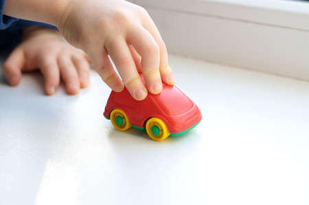 Little child hand close up playing toy machineの写真素材
