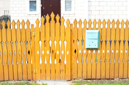 Orange yard fence with mailbox at house outdoor decoration