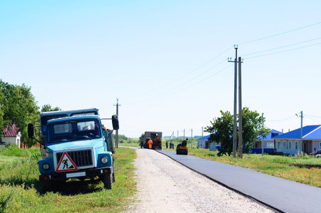 HALBSTADT, RUSSIAN FEDERATION - AUGUST 8, 2016: Constructing new asphalt in the village with...