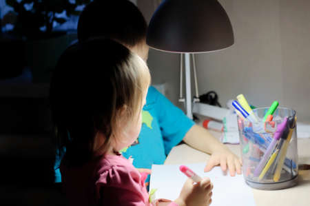 children painting evening home at lamp light,high isoの写真素材
