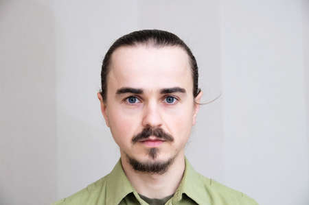 Mustache man portrait looking  at camera, handsome young men full face,bearded and seriousの写真素材