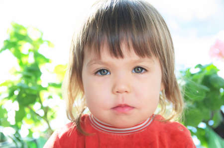 Child portrait with neutral face,caucasian little gril unemotional faceの写真素材
