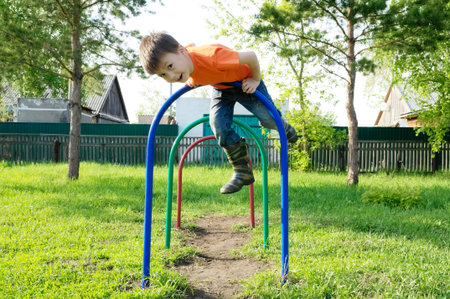 boy playing outdoors. Kid on playground,children activity. Child having fun. Active healthy...