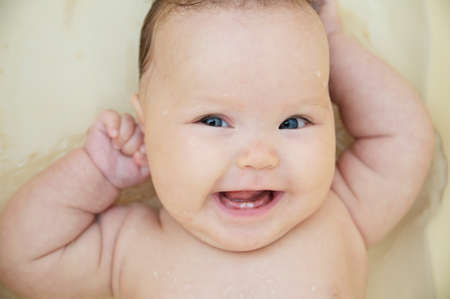 Happy smiling baby girl portrait in bath feeling good. Healthy lifestyle.の写真素材