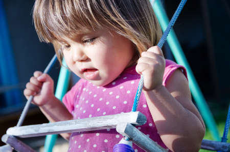 Toddler swing outdoor at summer, child playing activityの写真素材
