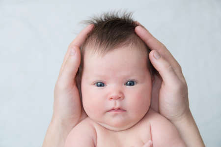 Infant baby in fathers hands, happy fatherhoodの写真素材