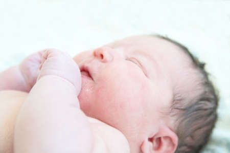 Newborn baby with umbilical cord first day of life sleeping cuteの写真素材