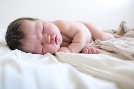 Newborn infant baby first day life sleeping on diapers