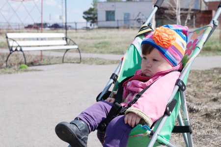 Little girl outdoor in stroller, walking with baby in buggy,  baby carriage using for child, pram...