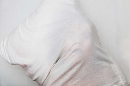 Child human face pressing through fabric. white background. child having funの写真素材