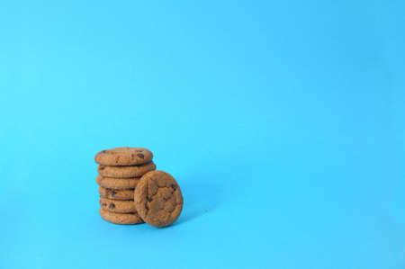 cookies on blue background. oatmeal cookie with pieces of chocolateの写真素材