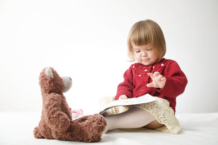 Story time. Little girl playing with teddy bear and doll. children education and happy childhood