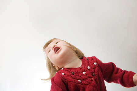 little girl smiling happy. cute caucasian baby with bear and doll isolated on white backgroundの写真素材
