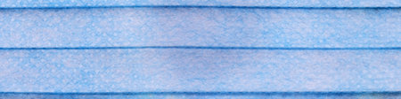 close-up blue surgical mask detail background