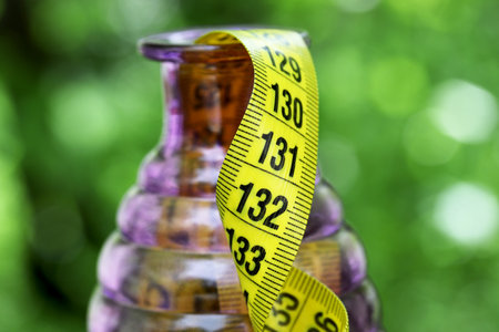 diet concept with measure tape in the gardenの写真素材