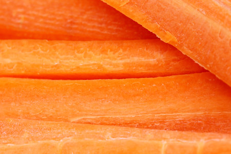 close-up slice of organic and fresh carrotsの写真素材