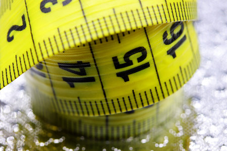 close-up yellow measuring tape on a background