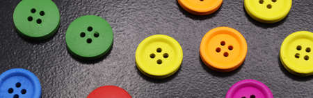 colored buttons on a black backgroundの写真素材