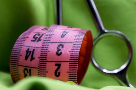 tailoring supplies and sewing accessories on fabric backgroundの写真素材